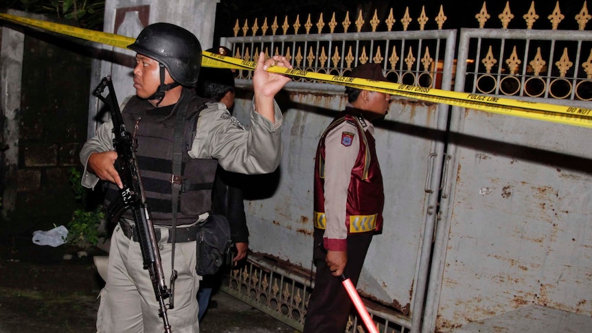 Indonesian police guard the crime scene of the shooting of alleged terrorist suspects in Bali