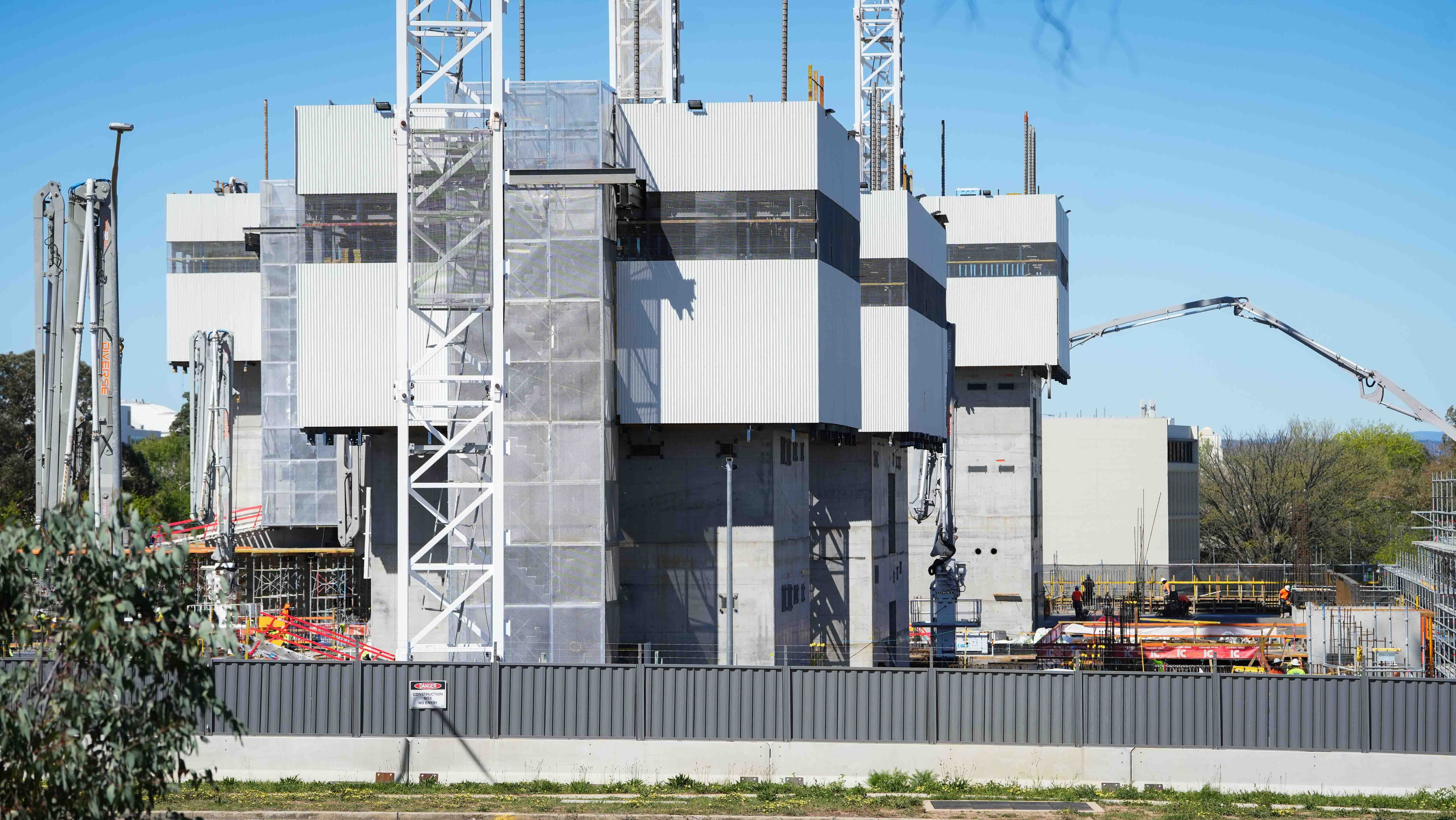 Workers constructing a large building.