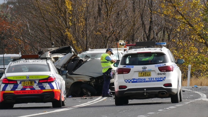 Two police cars and a crash vehicle 