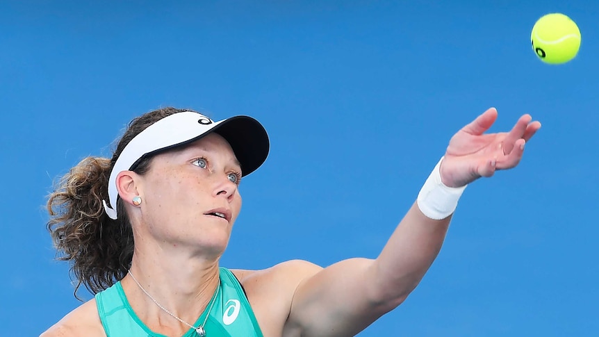 Sam Stosur watches a yellow tennis ball as she throws it up in the air