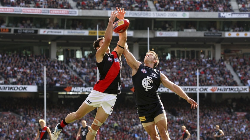 Ben Howlett and Marc Murphy fly high in competition for the ball.