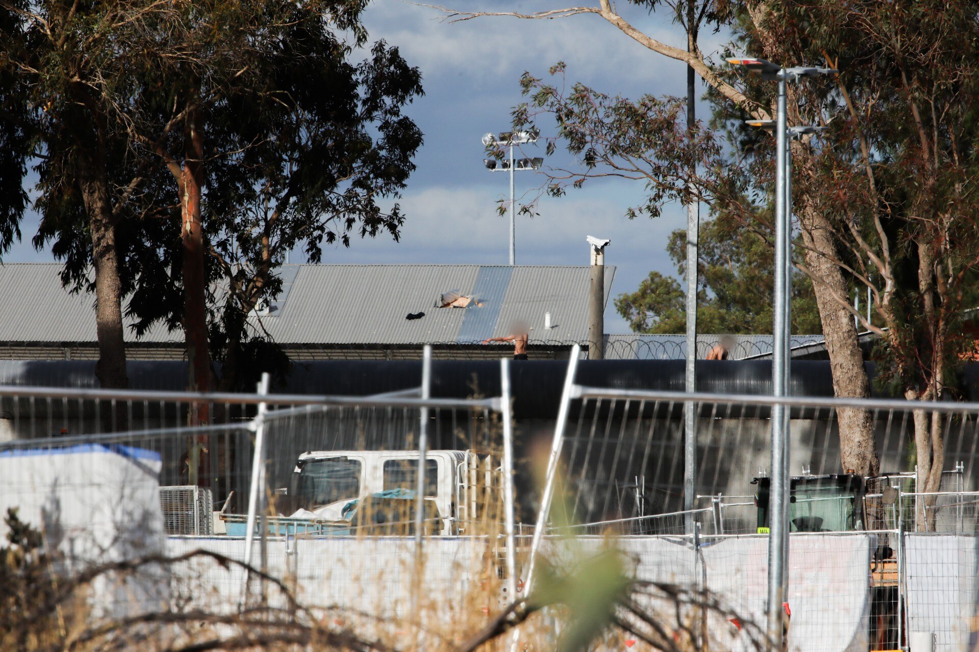 Una toma del techo de un edificio con algunas personas con caras borrosas. 