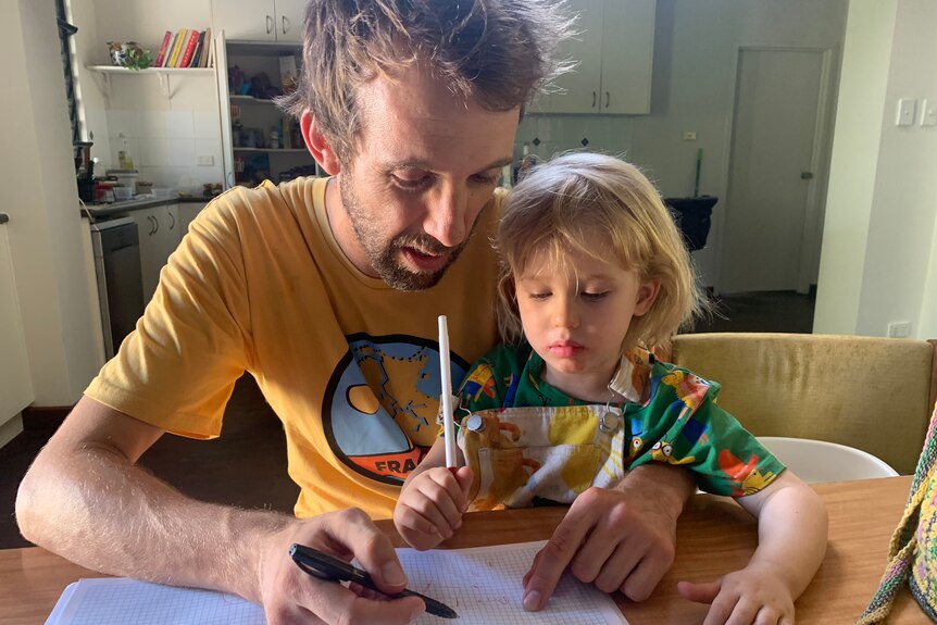 a dad drawing with his daughter