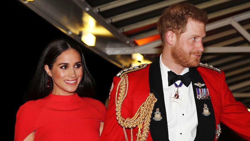 Prince Harry and Meghan, Duchess of Sussex, are seen in red arriving at the Royal Albert Hall.