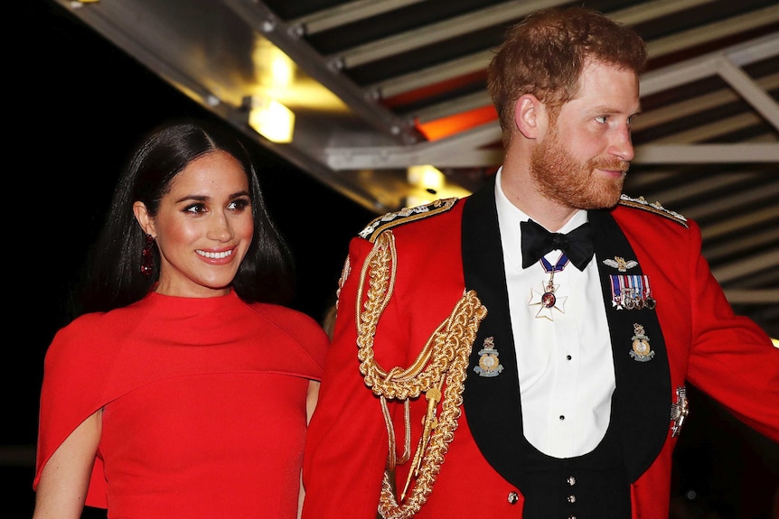 Prince Harry and Meghan, Duchess of Sussex, are seen in red arriving at the Royal Albert Hall.