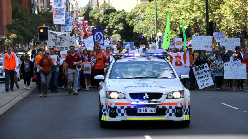 Protestors march along St Georges Terrace in Perth today, April 1, 2014.