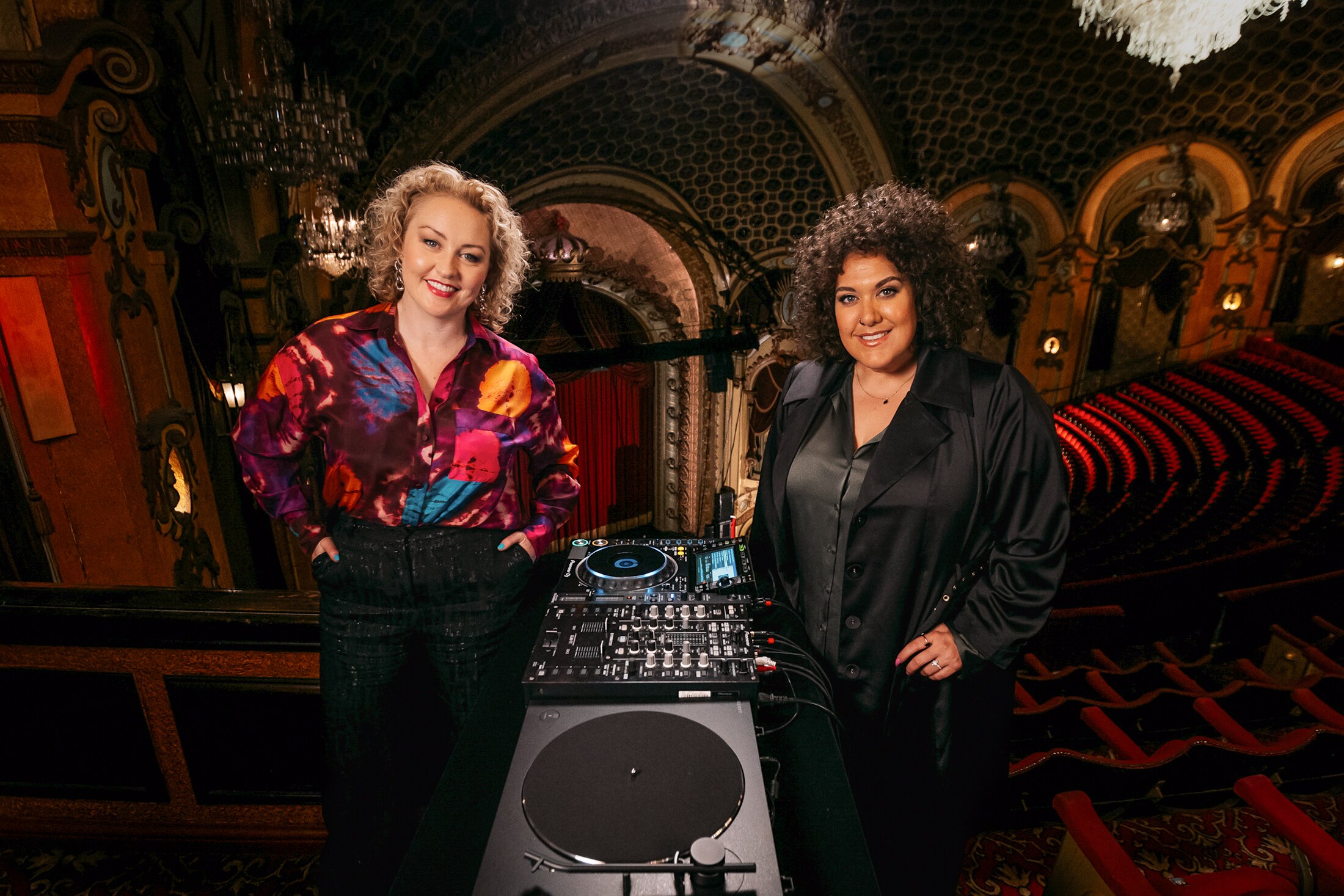 Casey Donovan poses in Sydney's State Theatre by a record player with mixing desk