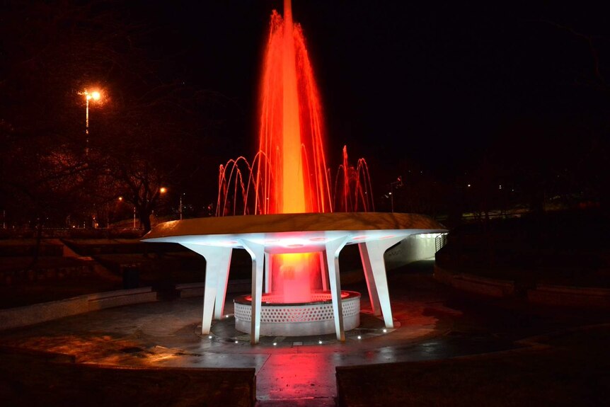 Hobart's roundabout fountain turns red