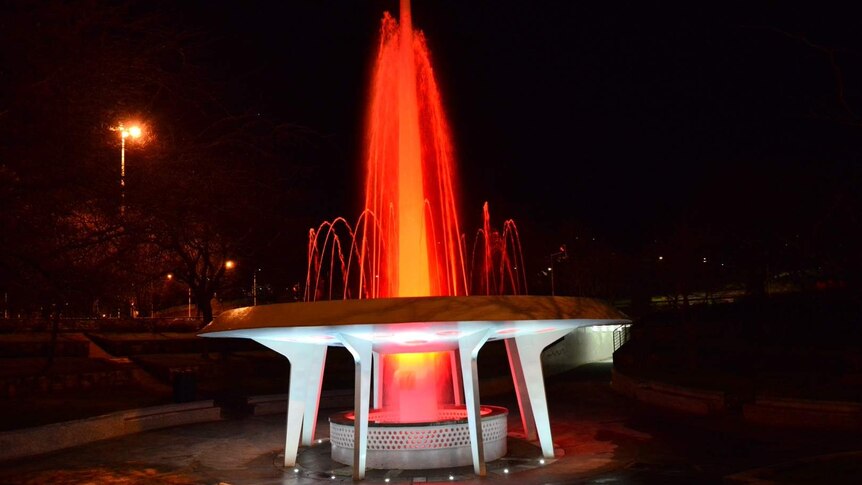 Hobart's roundabout fountain turns red