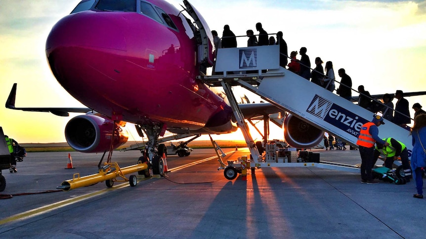 Passengers boarding an airplane.