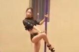 Pole dancer performs for children and parents