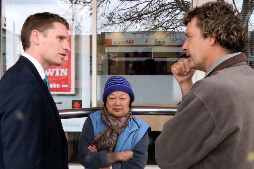 Andrew Hastie (L) speaks with Canning locals