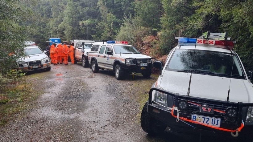 SES personnel in a huddle near vehicles during the search for Belgian tourist Celine Cremer.