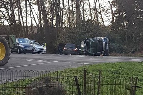 Overturned cars are seen to by police after a crash.