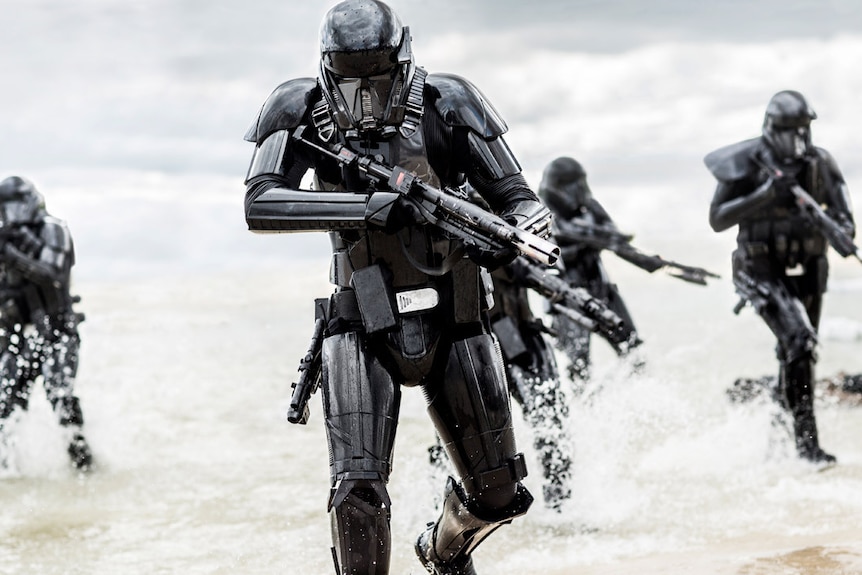 Deathtroopers storm a beach in a scene from Rogue One, 2016