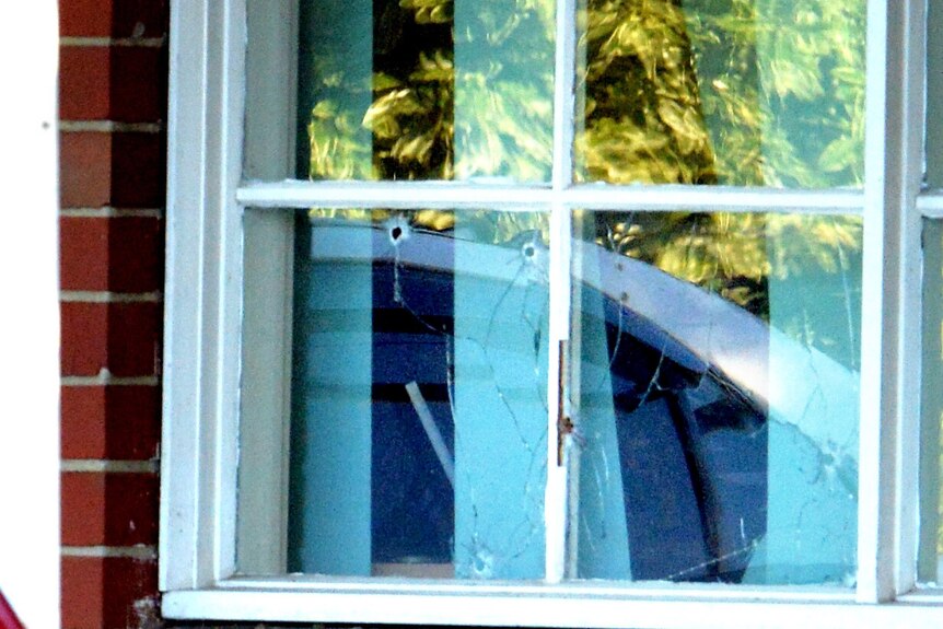 Bullet holes in a window of the house on Darebin Drive, Thomastown.