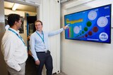 San Behrens, researcher at CSIRO Stored Energy Integration facility, points to screen showing battery life cycles