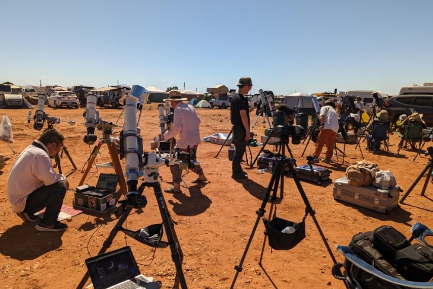 Cameras, telescopes and people in the red dirt of the outback. 