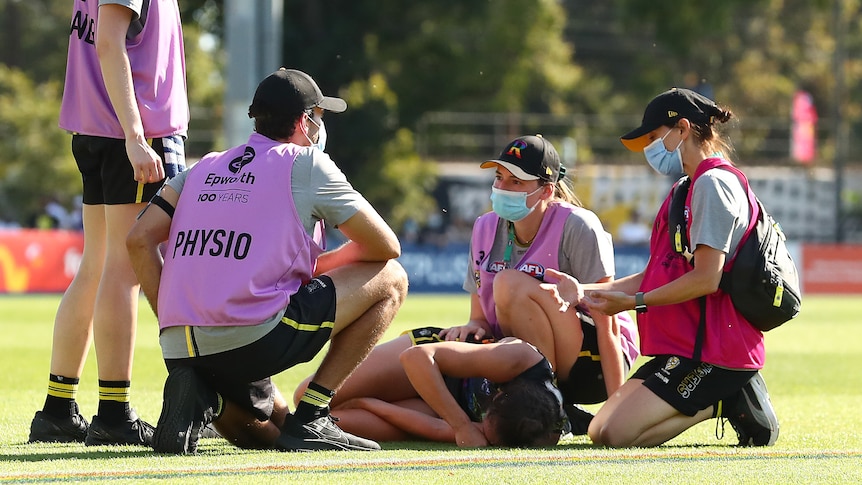 Richmond AFLW player Harriet Cordner receives medical attention after a collision during their round three match
