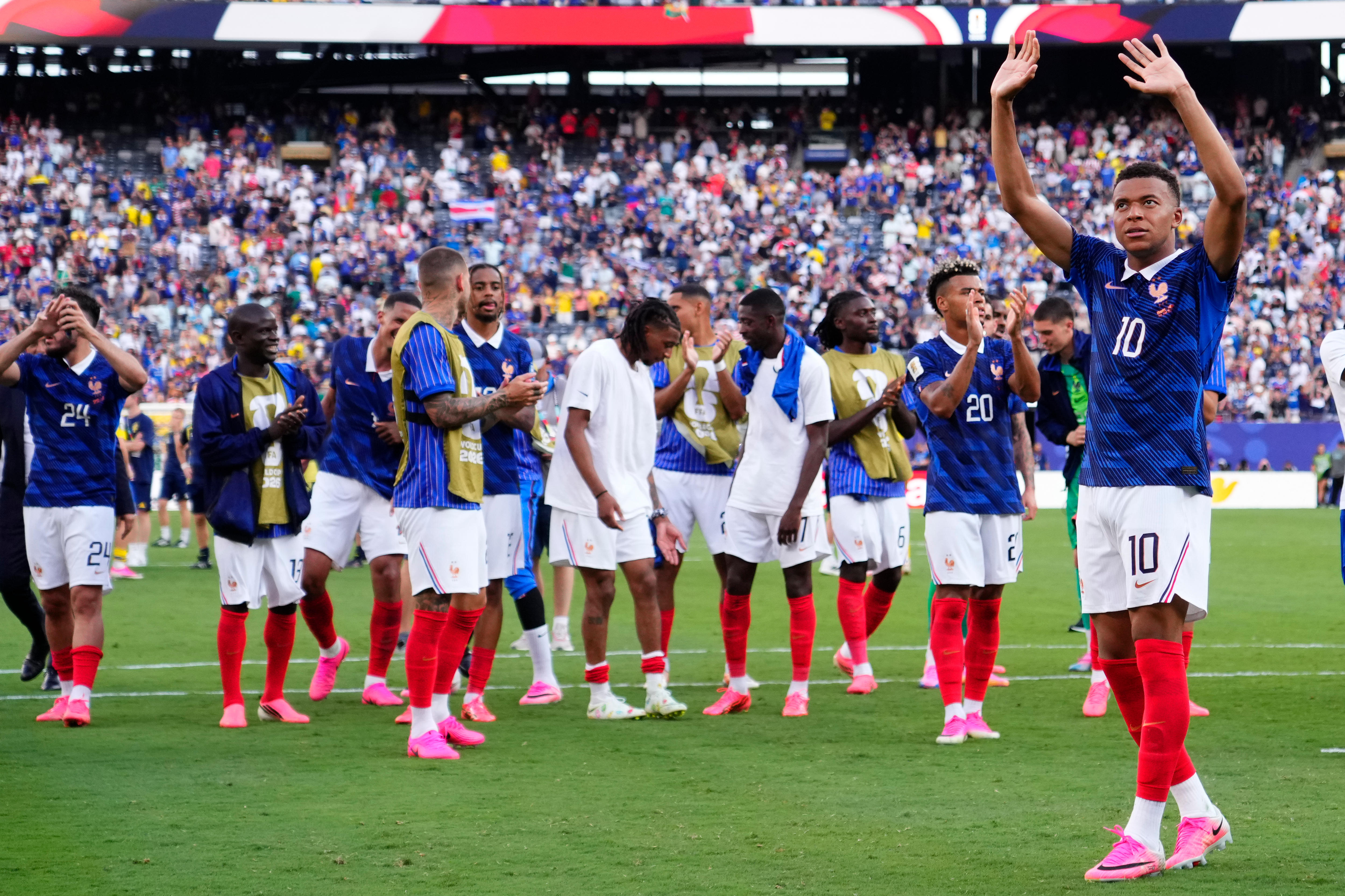 France player Kylian Mbappe applauds supporters along with his teammates