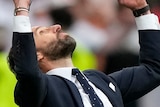 Gareth Southgate looks up, with his fists clenched above his head