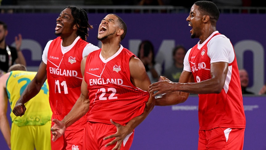 Myles Hesson of England celebrates with a teammate who tugs at his England singlet