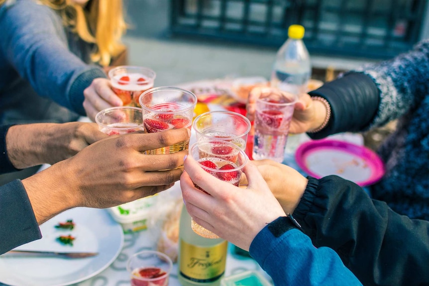 A group of friends raises a toast in order to help a lonely or bereaved person at Christmas
