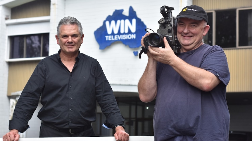 Two men, one holding a camera, at Mount Gambier's former television station site.
