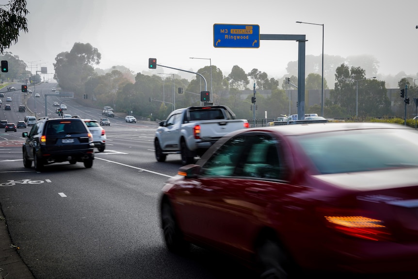 Cars turn onto the freeway, while others go straight