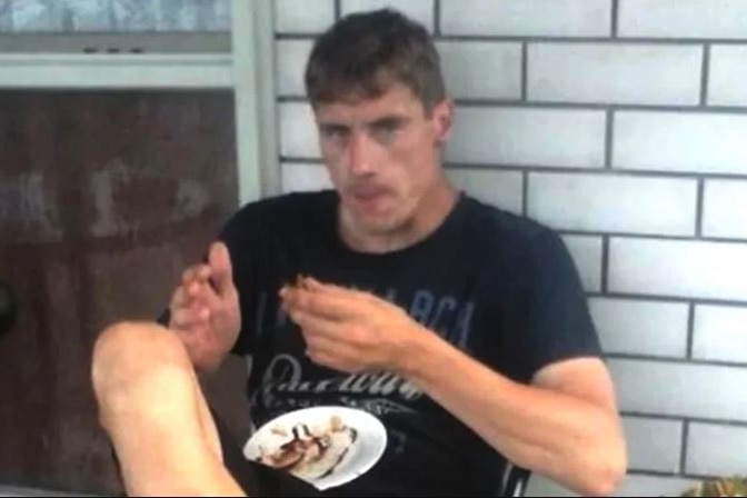 A man eating and looking at the camera