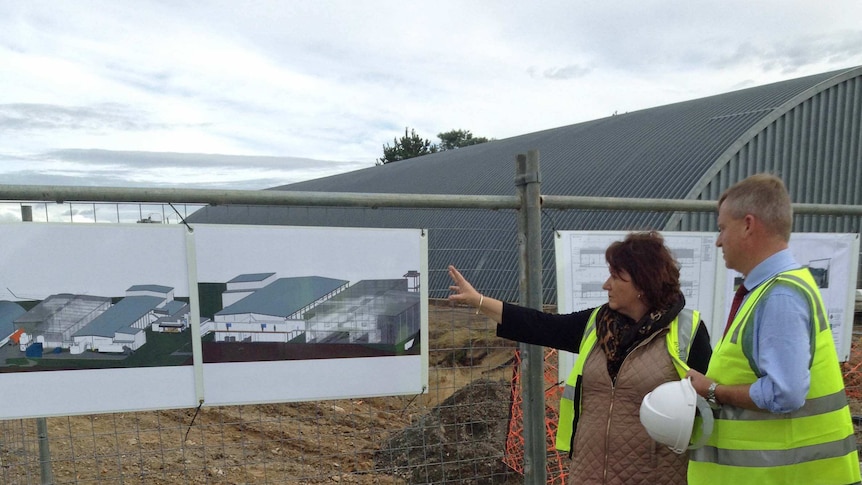 Huon Aquaculture's Frances Bender and deputy premier Jeremy Rockliff inspect a factory site.