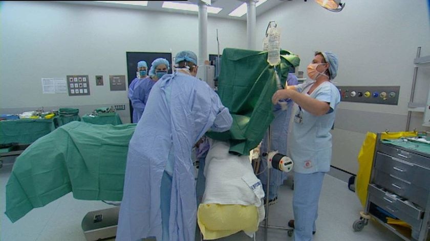 Generic TV still of anonymous medical staff working in operating theatre at an unidentified Qld hosp