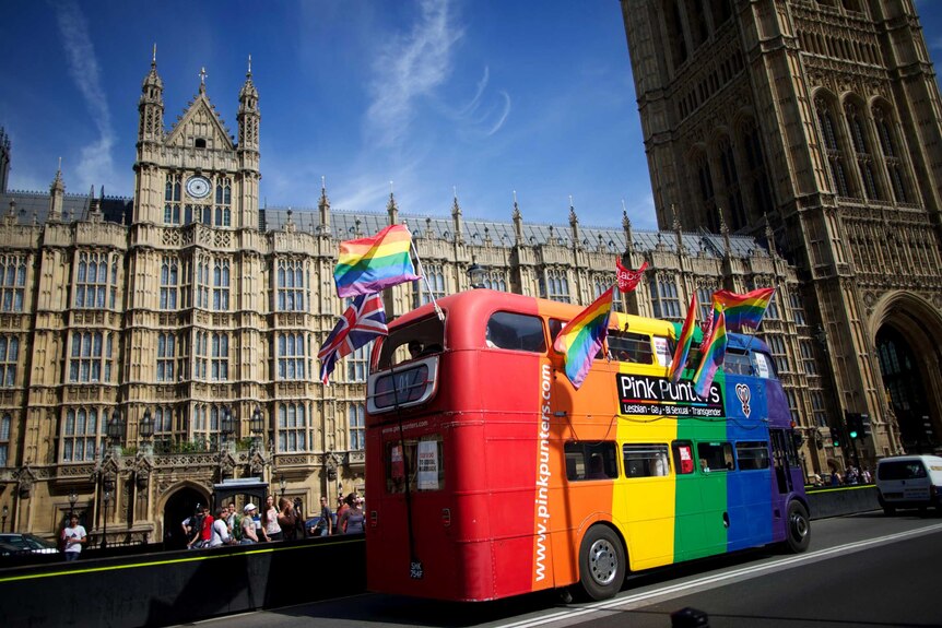 Gay campaigners celebrate outside the Houses of Parliament in London.