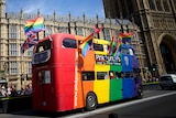 Gay campaigners celebrate outside the Houses of Parliament in London.