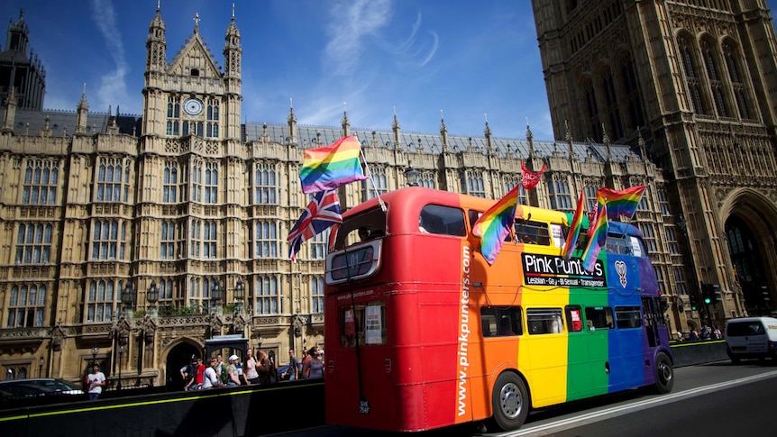 Gay campaigners celebrate outside the Houses of Parliament in London.