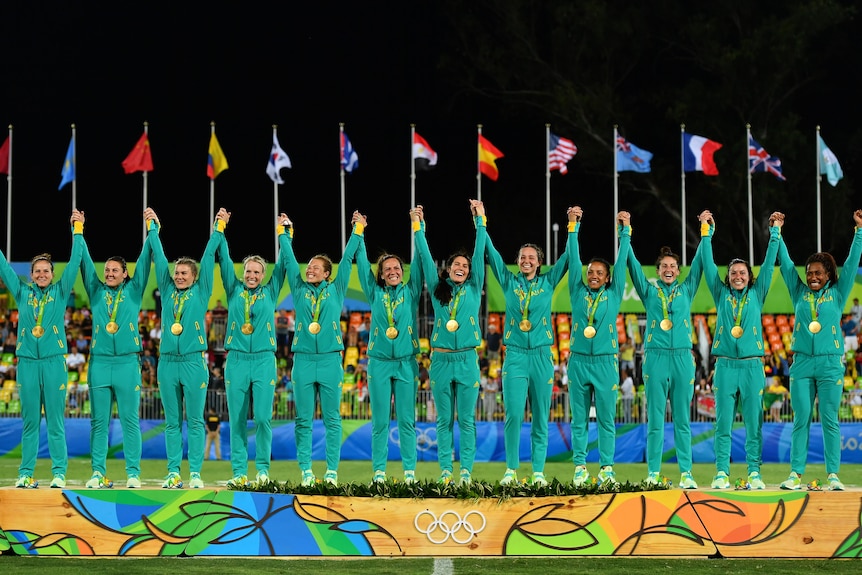 Australian team pose with their Rio Olympic gold medals after defeating New Zealand in the final 