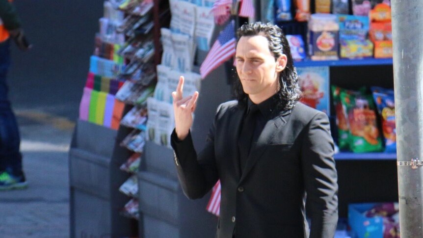 Tom Hiddleston makes the rock on symbol on the set of Thor in Brisbane.