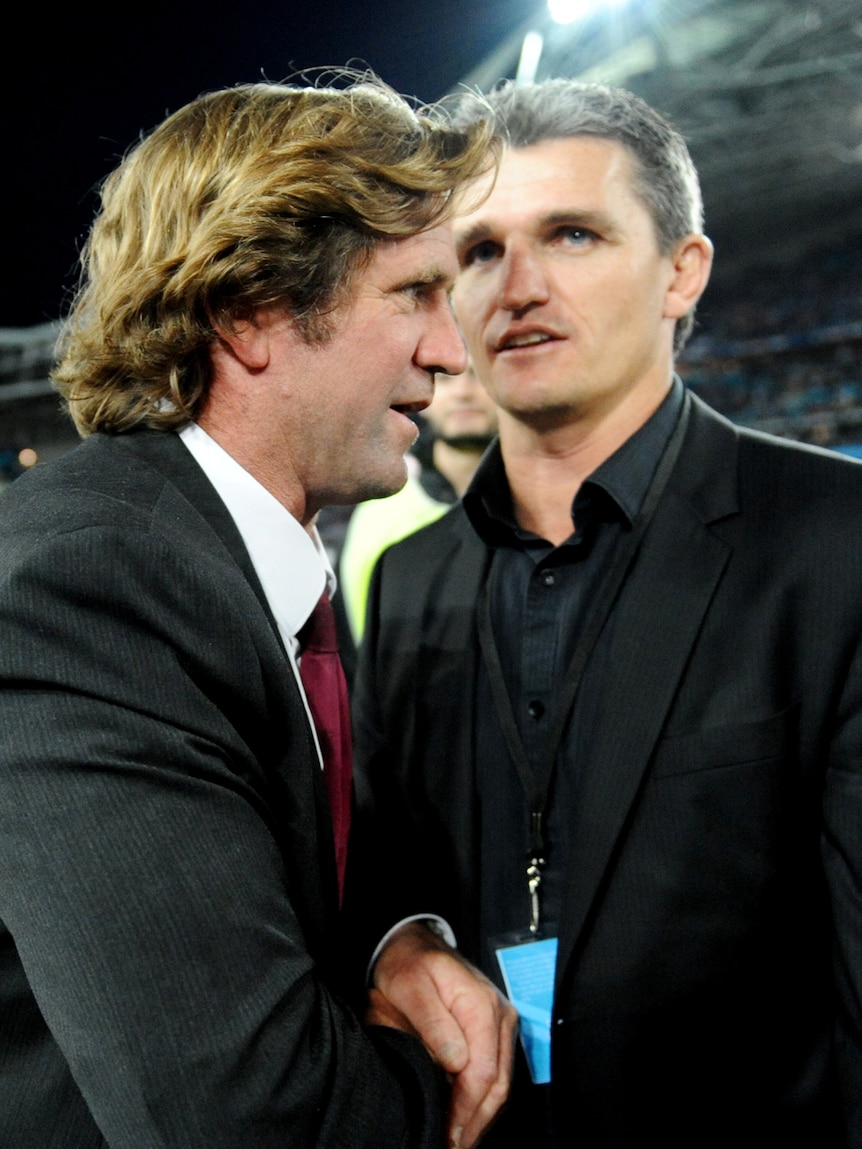 Warriors coach Ivan Cleary (R) congratulates Manly coach Des Hasler after the Sea Eagles secured the premiership.