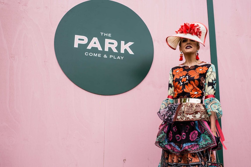A woman wearing a patterned dress to the Melbourne Cup.