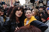 Asia Argento and Rose McGowan surrounded by reporters and cameras