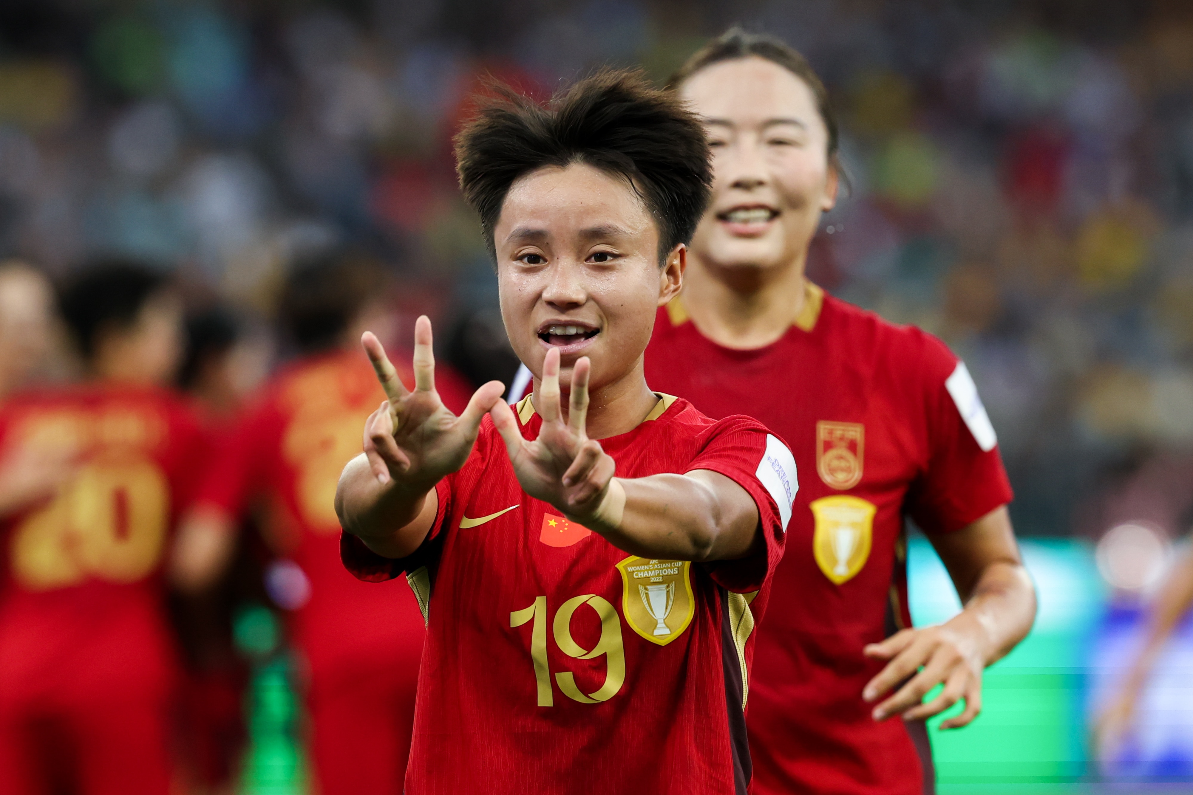 Chinese player Zhang Linyan holds up six fingers and smiles after scoring a goal