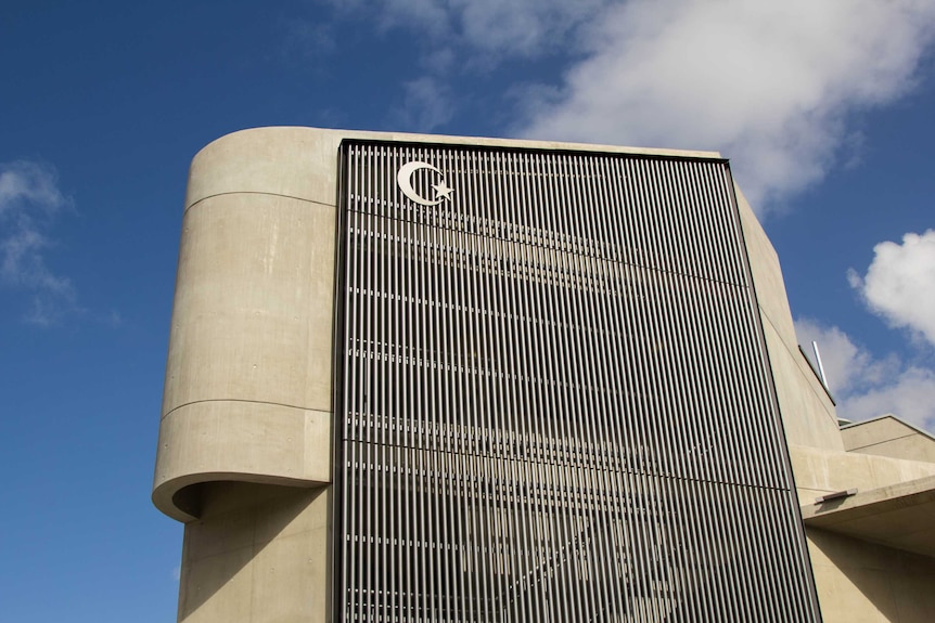 Low-angle shot of Punchbowl mosque's minaret with star and crescent symbol.