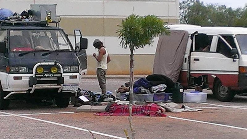Travellers' possessions sprawl across a car park in Broome.