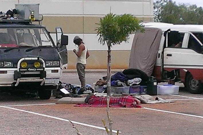 Travellers' possessions sprawl across a car park in Broome.