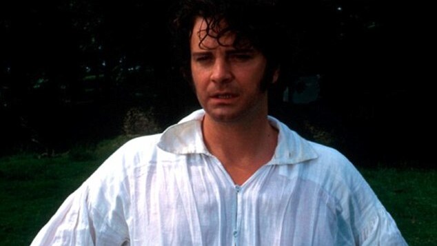 A man looks steamily at the camera in a wet shirt.