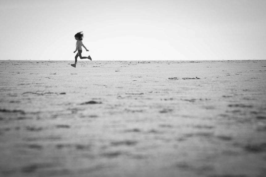 Girl running in desert