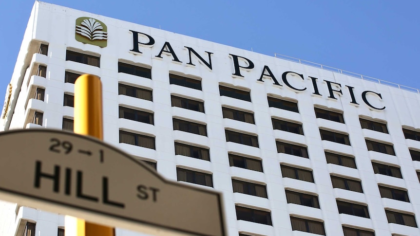 A white hotel with the words Pan Pacific on the side.