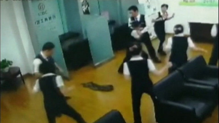 Python falls through roof during staff meeting at China bank