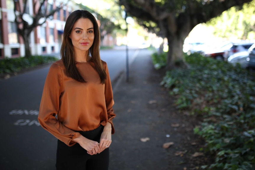 Irena Ceranic stands on an East Perth street, with trees and cars in the background.