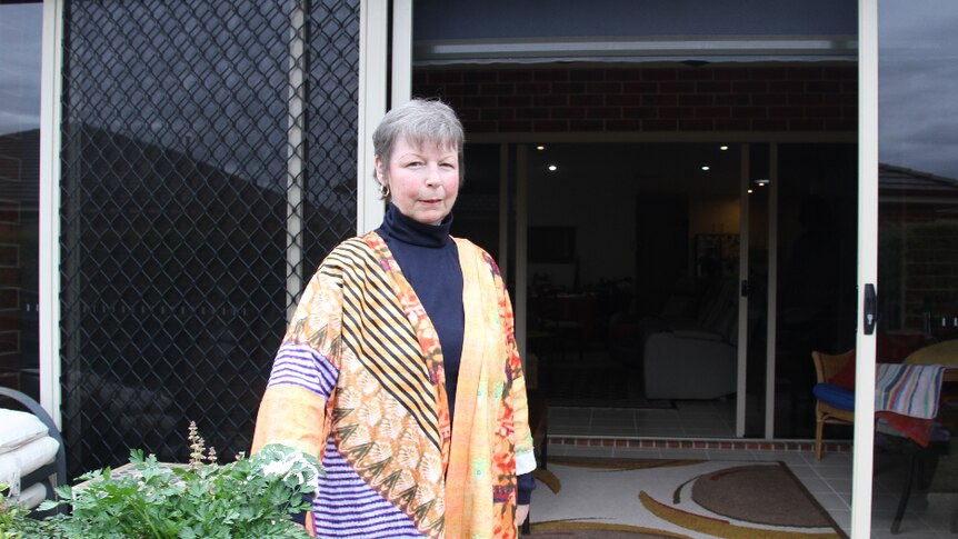 Albury resident Rae Gibbons stands standing in her backyard